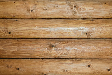 Fototapeta premium Wooden log wall texture background. Closeup wall of old wooden house.