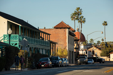 Late afternoon sun shines on the historic Basilica and historic district of San Juan Capistrano,...