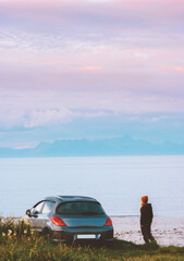 Road trip in Norway woman traveling by rental car adventure lifestyle concept vacations camping outdoor sunset mountains and fjord landscape