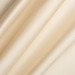 Fototapeta premium Smooth fabric texture with folds and wawes. Close up silk background