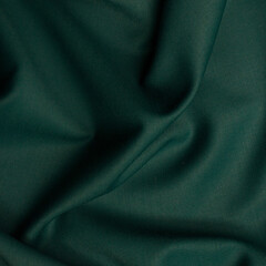 Smooth fabric texture with folds and wawes. Close up silk background