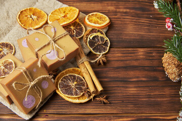 Bright handmade soap, various spices on the wooden countertop. Healthy lifestyle, natural products.