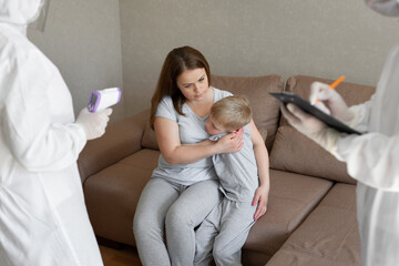 Doctor check patient body temperature using infrared forehead thermometer gun at home. Coronavirus,...
