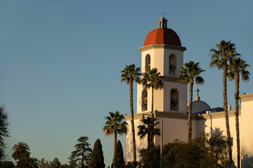 Late afternoon sun shines on the historic Basilica and historic district of San Juan Capistrano,...