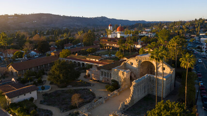 Sunset aerial view of the Spanish Colonial era mission and surrounding city of downtown San Juan Capistrano, California, USA. 