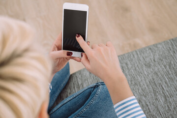 Young Woman Using Smartphone While Sitting on Couch at Home Hands With Mobile Phone