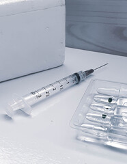 
syringe with elements of a vaccination campaign 