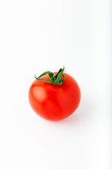 Single fresh red round tomato isolated on white background 