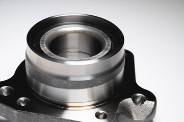 auto hub bearing new on gray background. metal spare part for front suspension