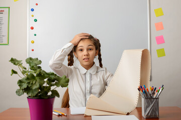 Exhausted girl showing the list of tasks to do, shocked by the amount of work, expressing surprise...
