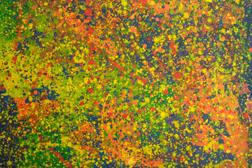 Multicolored splashes of paint on canvas. Suitable for background.