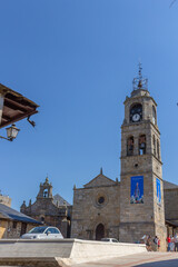 Puebla de Sanabria, Spain - September 6, 2020: Bell tower of Santa María del Azogue church (Iglesia de Nuestra Senora del Azogue) is a pretty village church that was first built in the 12th century.