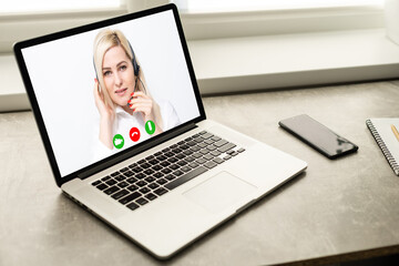 Young Female Doctor Video Chatting On Laptop In Clinic