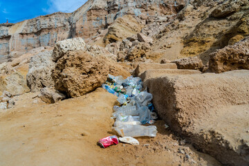 Dirty plastic bottles on the beach. Ecological problem. Beach pollution