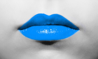 Female lips close-up with light soft blue lipstick bright juicy color on a background of black and white face.