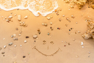 Smile painted on the sandy beach