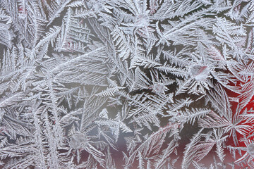 Beautiful winter background, frost on the window, natural texture on glass with a frozen pattern. Copy space, natural background, macro