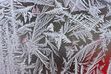 Beautiful winter background, frost on the window, natural texture on glass with a frozen pattern....
