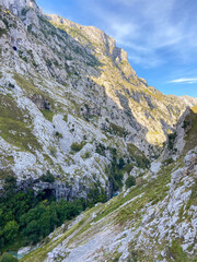 The Cares river canyon along the Cares Route in the heart of Picos de Europa National Park, Spain. Narrow and impressive canyon between cliffs, bridges, caves, footpaths and rocky mountains.