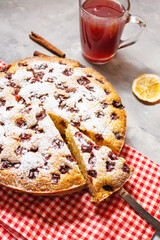 Delicious Homemade Cherry Pie and cup of compote, kissel on concrete background
