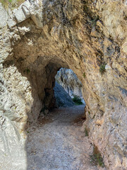 Tunnel pathway in Cares River canyon in Asturias. The Cares Route, placed in the very heart of Picos de Europa National Park, also known as “La Garganta Divina” (The Divine Gorge).