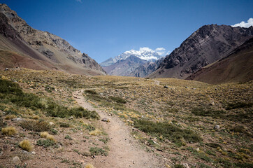 Andes Mountains landscape with hiking trail with no people and view to Aconcagua Peak. Aconcagua provincial park, Mendoza province, Argentina