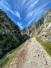 The Cares Route in the heart of Picos de Europa National Park, Cain-Poncebos, Asturias, Spain. Narrow and impressive canyon between cliffs, bridges, caves, footpaths and rocky mountains.