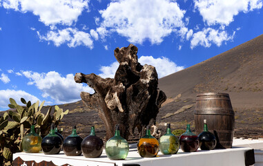 Wine and hard drink bottles and wooden statue on the table