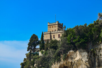 Fototapeta na wymiar City tower on a cliff near Mediterranean Sea in Finale Ligure, Savona, Italy.