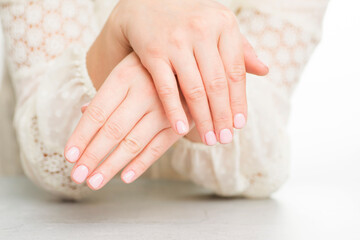 Obraz na płótnie Canvas Womans hands with beautiful manicure on white background