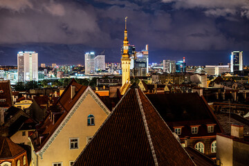 Fototapeta premium Panorama skyline of Estonian capital Talinn during night - old town in front of modern high-rise district