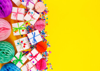 colorful gift boxes on a yellow background top view.