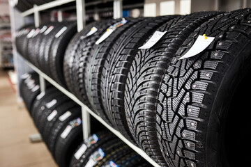 new and used automobile tires on the store rack. close-up photo of tires in automotive service