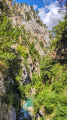 Cares river canyon along the Cares Route in the heart of Picos de Europa National Park, Spain. Narrow and impressive canyon between cliffs, bridges, caves, footpaths and rocky mountains