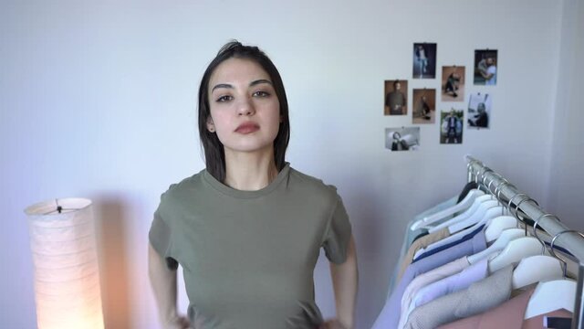 Close-Up Pretty  Woman Is  Trying on Modern New T-shirt