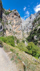 The Cares Route in the heart of Picos de Europa National Park, Cain-Poncebos, Asturias, Spain. Narrow and impressive canyon between cliffs, bridges, caves, footpaths and rocky mountains.