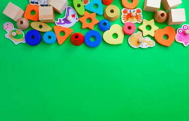 children's toys are laid out on a green background top view. space for text