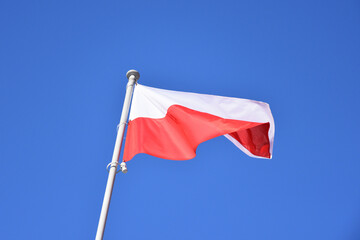 Poland, Polish national flag waving on a pole, close up - 411973072