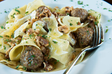 Pappardelle and Meatballs popular in the Tuscan region of Italy.  This wide egg pasta is perfect with heavy meat sauces.