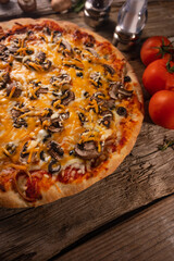 Italian food - pizza with salami and tomatoes, vertical, close-up