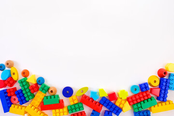 colorful children's toy constructors on a white background top view. Space for text