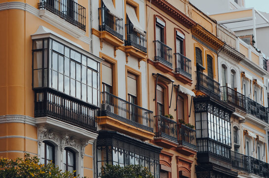 Row of traditional apartment blocks on a street in Seville, Spain.
