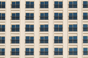 Hotel building facade with many windows on white wall