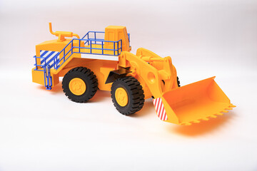 Plakat Scale model of a yellow single-bucket loader on white background