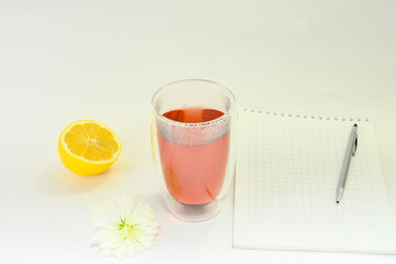 
Brewed tea with notebook and pen