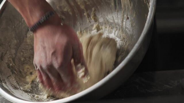 Slow motion shot: Chef kneads the dough for bread. 4k