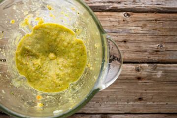 Green fresh smoothie mixed in a blender, top view. Healthy food concept
