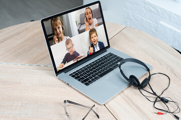 laptop with videoconference stands on the table