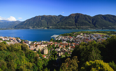 Fototapeta na wymiar above Locarno city switzerland during summer season with blue sky and sun, green trees beautiful hdr colorful