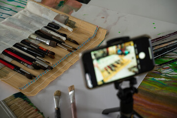 Preparing for an online workshop. Online training. painting technique and skill. recording video tutorial on camera.